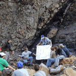 Neal Alexandrowicz '99 (pointing to poster) was back to teach during the 2002 Junior Seminar field trip.