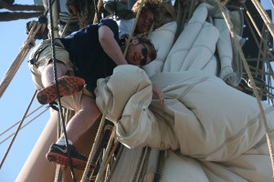 Harbor furling the main topmast stay sail with members of starboard watch, 3rd division. Photo by Cheryl Hatch/Copyright 2016